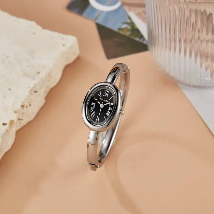 Montre ovale élégante pour femmes avec cadran en chiffres romains et bracelet en alliage à Quartz pour occasions spéciales