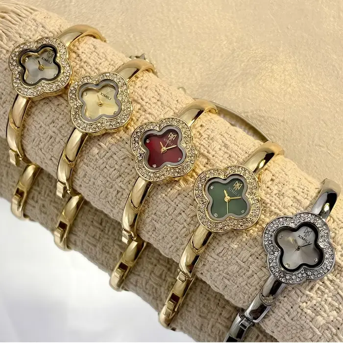 Montre-bracelet vintage en forme de trèfle à quatre feuilles pour femmes style fashion et casual avec mouvement quartz et choix de couleurs argent, blanc, or, rouge et vert