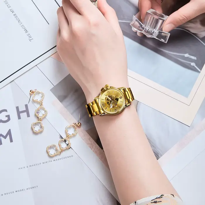 Montre T-Winner automatique pour femmes élégante squelette doré bracelet acier inoxydable pour événements sportifs et occasions spéciales